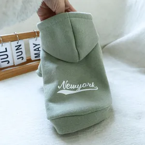 Detail of sage green pet hoodie featuring New York print on soft knit fabric