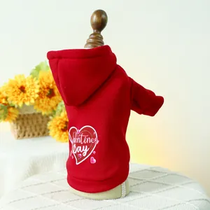 Detail of red Valentine's Day dog hoodie with heart pattern and ribbed cuffs