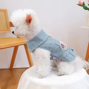 Light blue denim pet vest with heart embroidery on a Pomeranian in cozy home setting