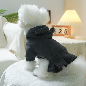 Close-up of a grey pet hoodie dress with pleated skirt on a small white dog