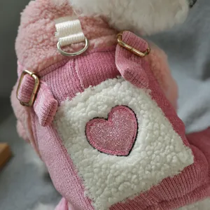 Close-up of pink heart sequin on fuzzy fleece pet overall with corduroy and metal buckle
