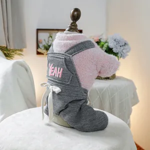 Detail of pink fleece interior and grey waffle knit pet overalls with YEAH embroidery