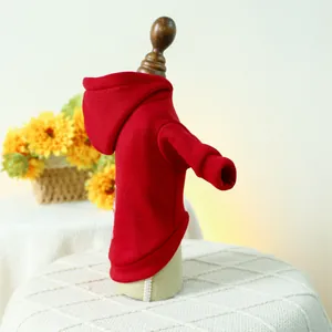 Detail of red pet hoodie with hood and ribbed cuffs shown on a wooden mannequin