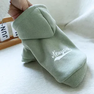 Detail of sage green pet hoodie featuring Newyork lettering and soft cotton texture