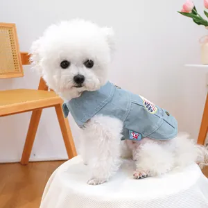 Close-up of light blue denim pet vest featuring red, white and blue embroidery on a dog