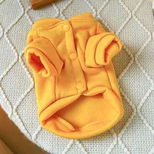 Detail of bright yellow fleece pet sweatshirt featuring three functional snap buttons