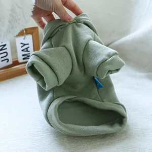 Close-up of green pet hoodie showing knitted ribbed cuffs and soft cotton texture