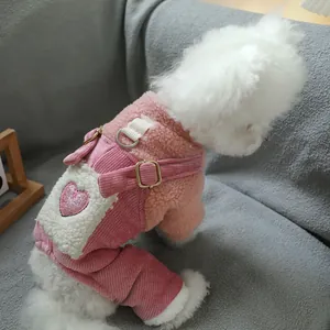 Detail of pink fleece pet outfit with sequined heart pattern and D-ring on small dog