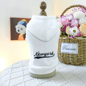 Close-up of white cotton pet hoodie with Newyork print on a wooden hanger model