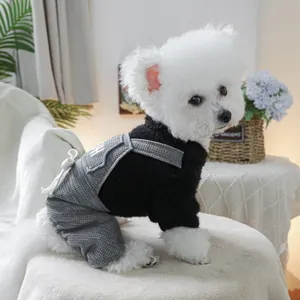 Detail of pet autumn plush top and plaid jumpsuit with a cute white bow decoration