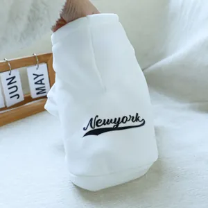 Close-up of white hooded pet sweatshirt featuring black Newyork lettering on the back