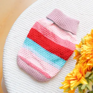 Close-up of a colorful striped pet sweater with high collar and ribbed knit texture