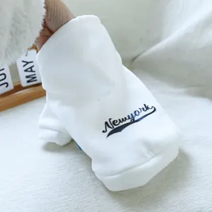 Detail of white pet hoodie with navy New York script lettering and soft fleece fabric
