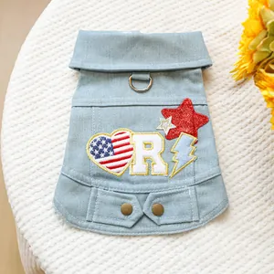 Close-up of light blue denim dog vest with American star embroidery and D-ring detail