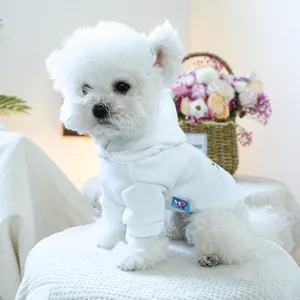 Detailed close-up of a white pet hoodie with soft fleece fabric and blue woven label