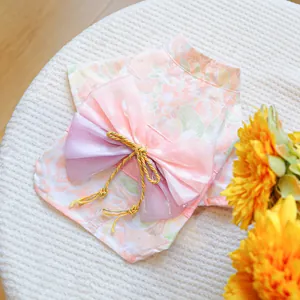 Detail of pink floral pet kimono with layered tulle bow and golden cord accent