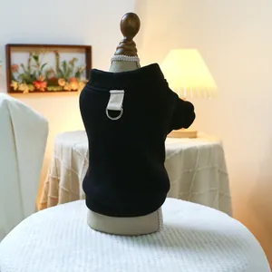 Detail of black pet vest with metal D-ring leash attachment on thick fabric
