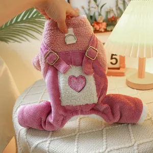 Detail of pink fleece pet overalls with plush heart patch and metal D-ring attachment