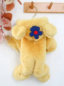 Detail view of yellow plush pet jumpsuit with floral patch and soft flannel texture