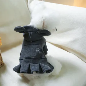 Detail of dark grey pet hoodie dress with rabbit ears and pleated skirt on a dog