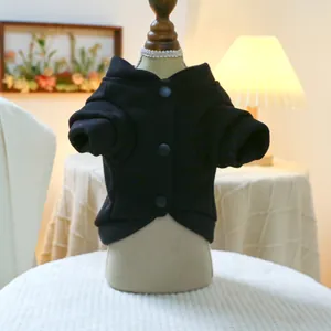Close-up of black pet cardigan with buttons and elastic cuffs on display stand