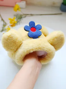 Macro detail of plush pet four-legged coat featuring blue plush flower and soft ears