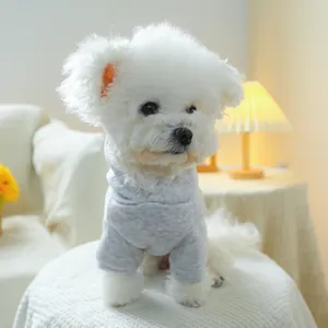 Close-up of soft grey knit hoodie for small dogs in a cozy indoor home setting