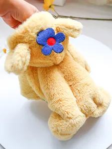 Detail of yellow plush puppy toy featuring a blue floral headpiece and soft fuzzy texture