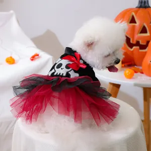 Detail of dog Halloween tutu dress with glitter skull pattern and red satin bow