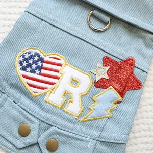 Close-up of pet denim vest with American flag heart embroidery and metal D-ring