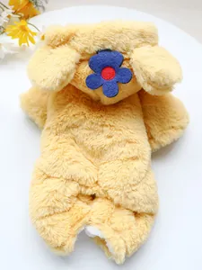 Detail of yellow plush dog jumpsuit with blue flower accent and soft velvet texture