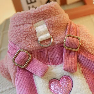 Detail of pink fleece pet overall featuring corduroy straps and a sequined heart pocket