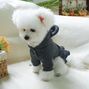 Detail of dark grey pet hoodie with wavy ruffled edges on a small white dog