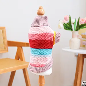 Detail of colorful striped pet sweater with high collar on wooden display stand