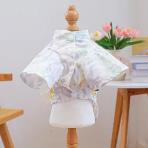 Detail of floral pet kimono shirt on a wooden mannequin with a cozy home backdrop