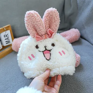 Detail of plush pet bunny hat with pink ears and embroidered facial features