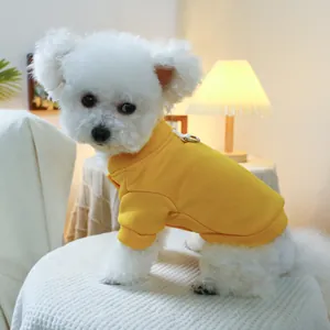 Detail of yellow cotton dog sweatshirt with metal D-ring for leash attachment