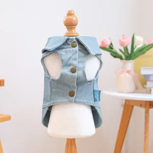 Detail of light blue pet denim vest featuring shirt collar and brown buttons on a model