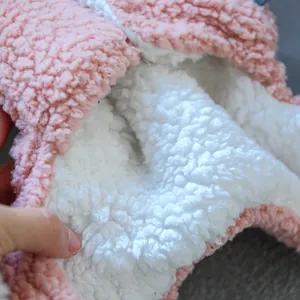 Detail of pink sherpa fleece pet jacket showing thick white plush lining and soft texture