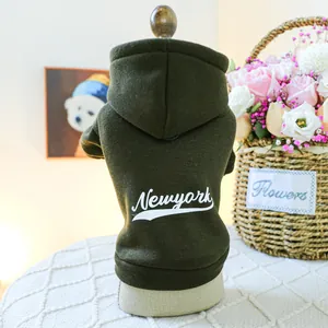Detail of dark green dog hoodie with white New York text print and thick warm fabric