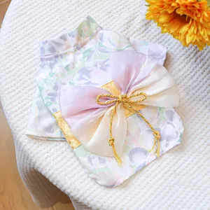 Detail of pet kimono featuring a purple floral pattern with a layered bow and golden tassel