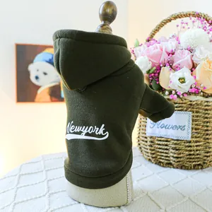 Detail of olive green dog hoodie with New York embroidery on plush cotton fabric