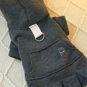 Detail of dark grey knit dog dress showing mini pocket with R embroidery and D-ring