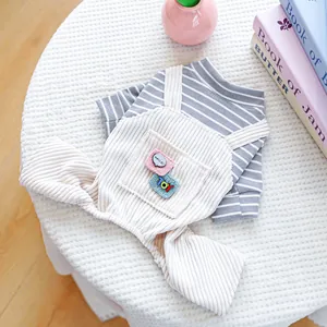 Striped pet t-shirt and corduroy overalls set for small dogs and cats on a white stool