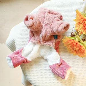 Close-up of pink pet jumpsuit with plush lining and corduroy fabric on waffle background