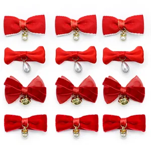 Detail view of 12-piece red pet bow set with pearls and bells in a grid display