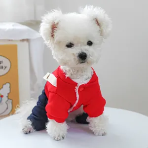Detail of red fleece hoodie and denim overalls on a small white fluffy dog