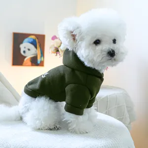 Close-up of olive green pet hoodie with ribbed cuffs and white lettering on a dog