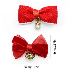 Detail of cute red pet bow clips with pearl and bell accents showing 5cm size dimensions