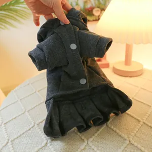 Detail view of a charcoal grey pet dress with soft cotton fabric and snap buttons
